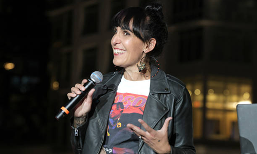 Felicia Viator smiling with a mic in her hand