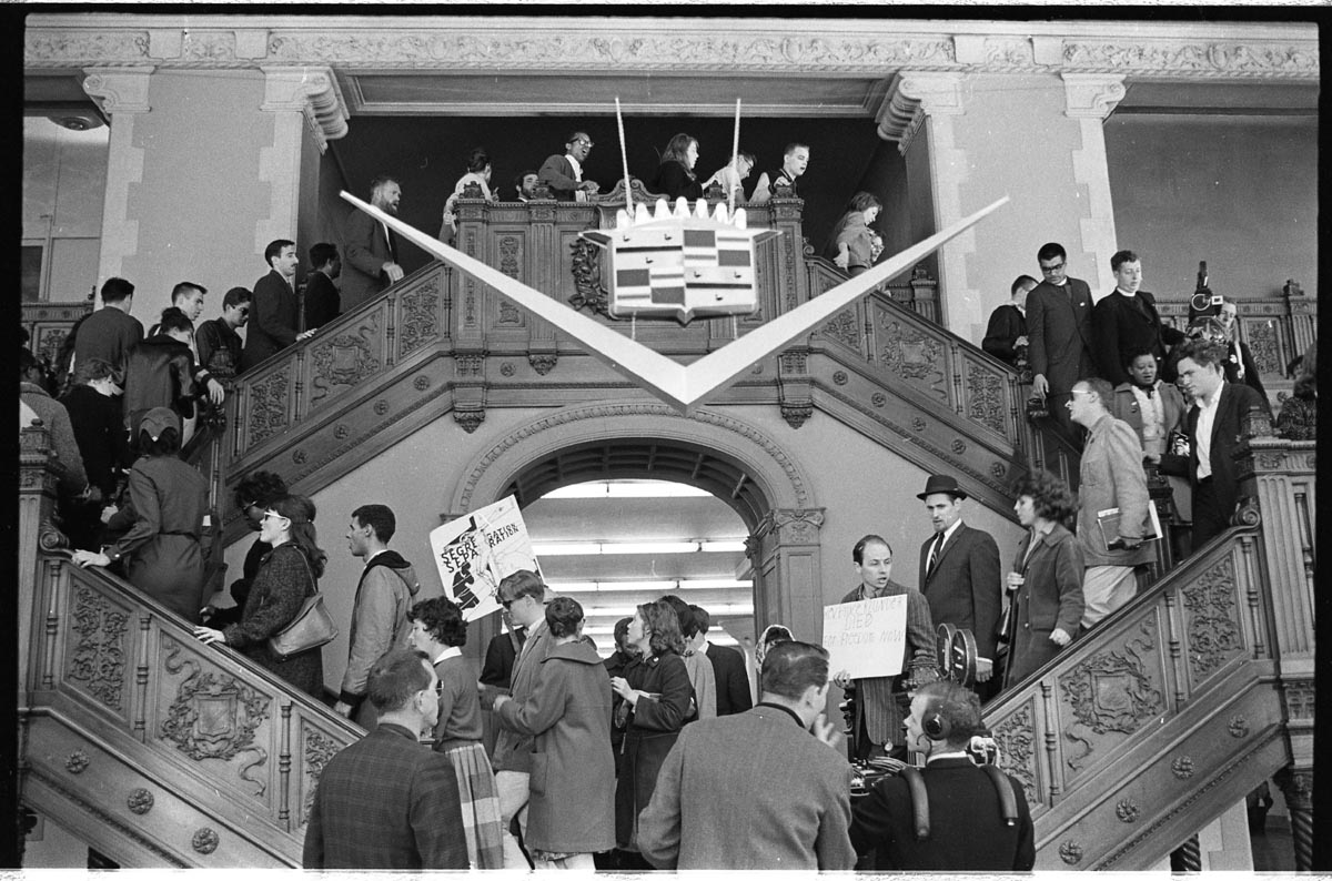 People lined up on stairs and inside of building